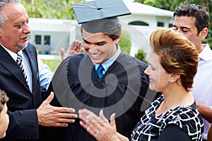 Hispanic Student And Family Celebrating Graduation