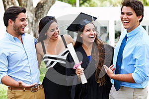 Hispanic Student And Family Celebrating Graduation