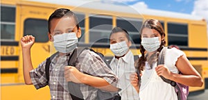 Hispanic Students Near School Bus Wearing Face Masks