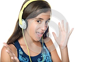 Hispanic teen listening to music with an excited expression