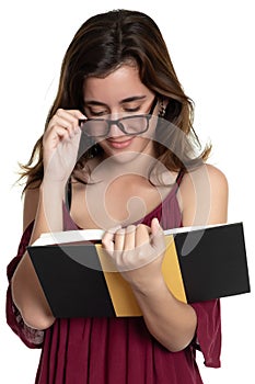 Hispanic teenage girl with glasses reading a book - On a white background