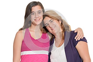 Hispanic teenage girl hugs her mother isolated on white