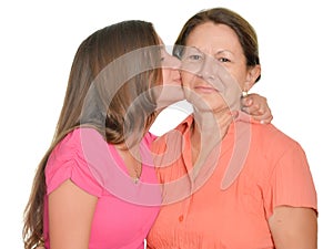 Hispanic teenage girl kissing her grandmother