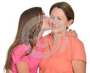 Hispanic teenage girl kissing her grandmother