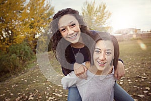 Hispanic Teenage girls having fun together outdoors