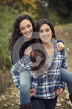 Hispanic Teenage girls having fun together outdoors