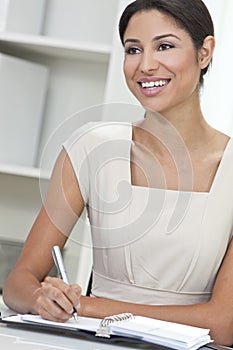 Hispanic Woman Businesswoman Writing in Office