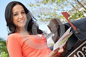 Hispanic Woman Checking Mailbox