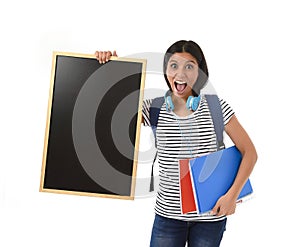 Hispanic woman or female student holding blank blackboard with copy space for adding message