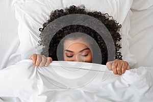 Hispanic Woman Hiding Her Face Under Blanket