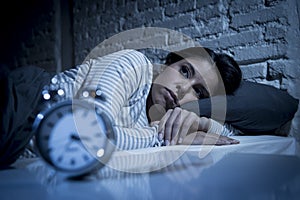 Hispanic woman at home bedroom lying in bed late at night trying to sleep suffering insomnia photo
