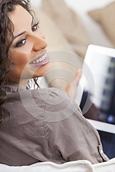 Hispanic Woman Laughing Using Tablet Computer