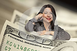 Hispanic Woman Leaning on a One Hundred Dollar Bill