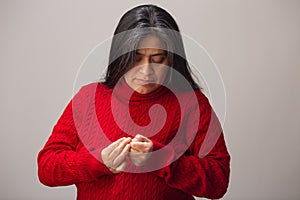 Hispanic Woman Looks And Inspects Fingers