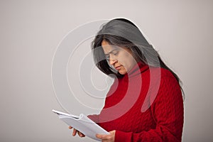 Hispanic Woman Looks At Notebook