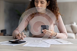 Hispanic woman manage finances using smartphone gadget