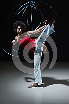 Hispanic woman playing capoeira martial art