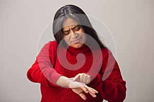 Hispanic Woman Points To Age Spots On Arm