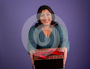 Hispanic Woman presenting a Christmas gift