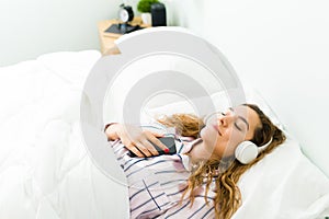 Hispanic woman relaxing with a meditation in her bedroom