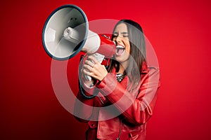 Hispanic woman shouting angry on protest through megaphone