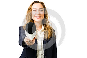 Hispanic woman smiling while doing a news interview