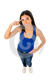 Hispanic woman smiling happy in top and jeans pointing her head thinking
