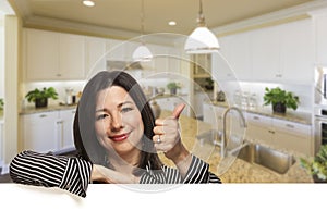 Hispanic Woman With Thumbs Up in Beautiful Custom Kitchen