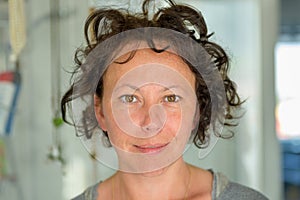 Hispanic woman with tousled curly hair