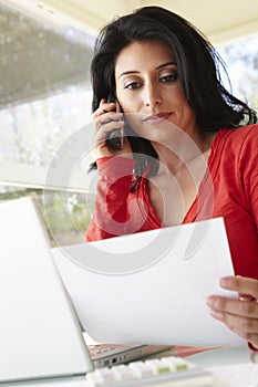 Hispanic Woman Working In Home Office