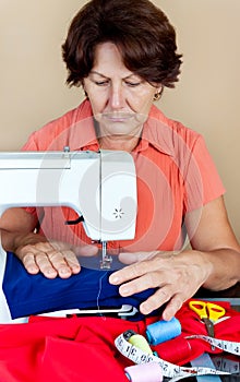 Hispanic woman working on a sewing machine photo
