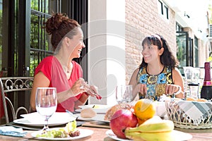 Hispanic women enjoying an outdoor home meal together