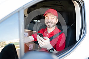 Hispanic worker delivering packages in a delivery truck