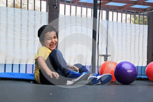 Hispanic 6-year-old boy jumping on a brincolin as a physical activity for a healthy life he exercises and has fun alone at home photo