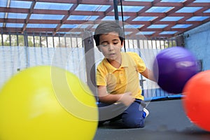 Hispanic 6-year-old boy jumping on a brincolin as a physical activity for a healthy life he exercises and has fun alone at home photo