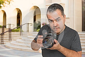 Hispanic Young Male Photographer With DSLR Camera Outdoors