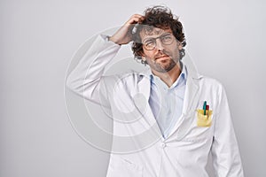 Hispanic young man wearing doctor uniform confuse and wonder about question