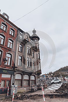 Historic Architecture in Dinant: Rainy Day Charm with Open Road