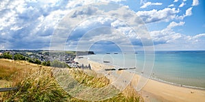 Historic beach in Normandy in a cloudy blue day photo