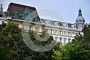 Historic and beautiful palace, seen from above the trees and under the blue sky in Vienna.