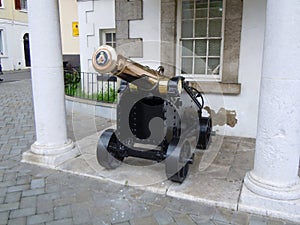 Historic brass cannon on city street