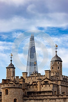 Historic Brick Building, Tower of London, in a modern city during cloudy blue sky morning. London