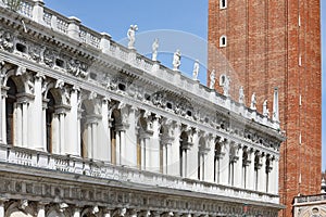 historic building called BIBLIOTECA MARCIANA in Venice in Italy and the bell tower of St Mark