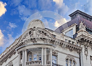 Historic building detail with dramatic blue cloudy sky