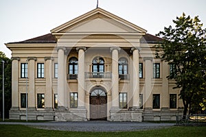 Historic building with front portico and colonnade