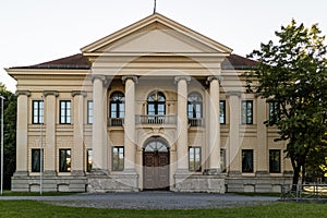 Historic building with front portico and colonnade