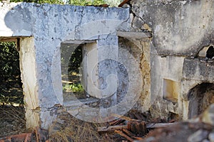 Historic building ruins with dirt and grass growing. Old ancient house or home broken and damaged. Open window in thick