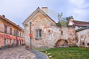 Historic Building In Stone And Bricks With Old Windows