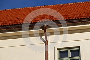 A historic building on which a caper rainwater drainage system with caper drain pipes is installed. Restored clay tile roofing