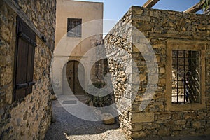 Historic buildings on the island in the fortress of Spinalonga in Crete. Boat trip to the island of lepers